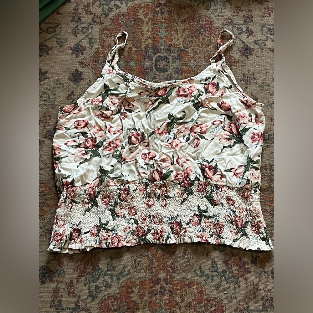Cute white top with floral design.